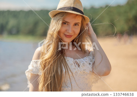 Portrait of girl in beach hat on summer day outdoors. High quality photo 133746638