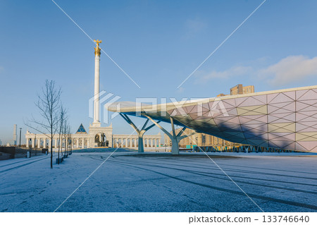 Panoramic view of Monument Kazakh people and Peace Wall on sunny winter day. Cityscape of Independence Square in city Astana, Kazakhstan. Word PEACE in different languages is written on wall 133746640