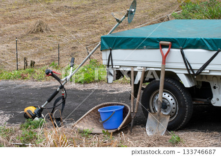 Farm tools unloaded from a light truck 133746687