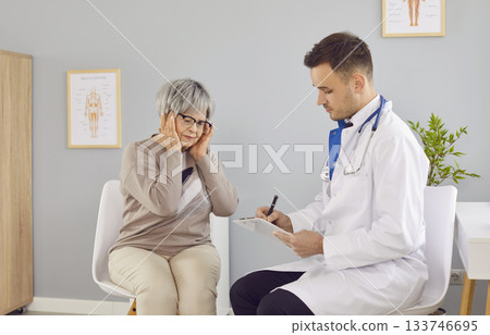 Headache problem complaint to doctor during clinic visit, taking care of old woman 133746695