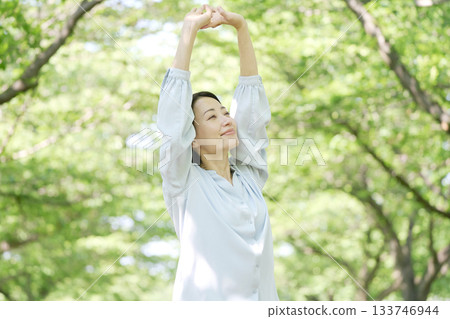 A woman in her 40s stretching outdoors A woman in her 40s stretching outdoors 133746944