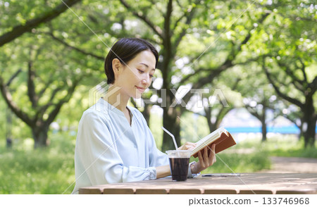Woman reading outdoors Woman reading outdoors 133746968