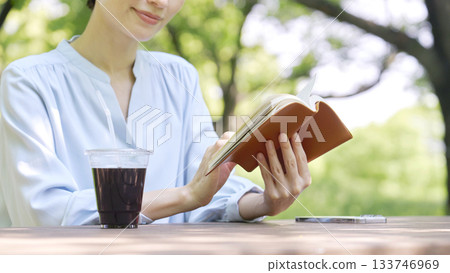Woman reading outdoors Woman reading outdoors 133746969