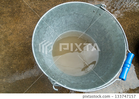 Bucket of muddy water 133747157