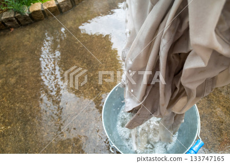 Washing dirty work clothes after rice planting Washing dirty work clothes after rice planting 133747165