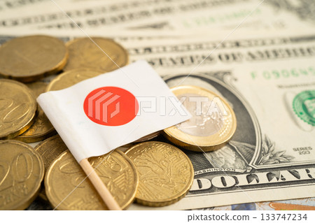 Stack of coins with Japan flag and US dollar banknotes. 133747234