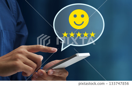 Customer satisfaction. Very satisfied and five star rating. Man using smartphone to send customer feedback Customer satisfaction. Very satisfied and five star rating. Man using smartphone to send customer feedback 133747856