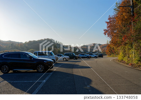 Parking lot along the road during autumn foliage season Parking lot along the road during autumn foliage season 133748058
