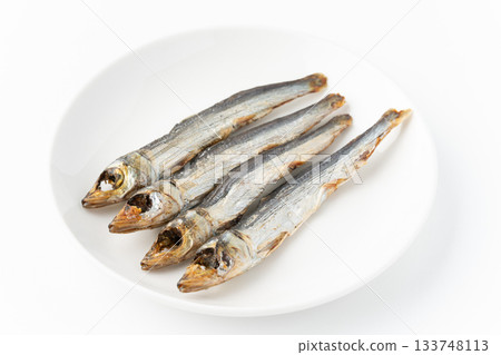 Grilled dried urume (round dried fish) on a plate on a white background 133748113
