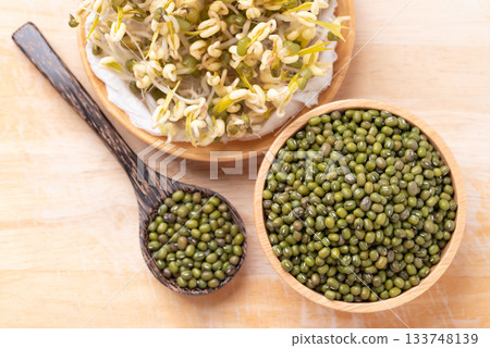 Mung bean seeds and sprouts on wooden background, Food ingredient in Asian cuisine Mung bean seeds and sprouts on wooden background, Food ingredient in Asian cuisine 133748139