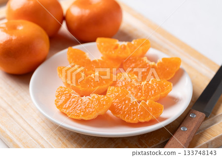 Fresh cut of Mandarin orange fruit on plate ready to eating 133748143