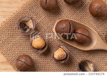 Macadamia nuts on brown background, Top view Macadamia nuts on brown background, Top view 133748174