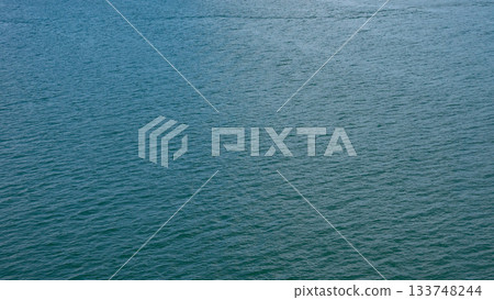 Sea water surface. Ripple water of ocean. Aquamarine ocean nature. Background of clear turquoise sea water. Idyllic summer vacation. Caribbean sea. Aerial view. Rippled surface Sea water surface. Ripple water of ocean. Aquamarine ocean nature. Background of clear turquoise sea water. Idyllic summer vacation. Caribbean sea. Aerial view. Rippled surface 133748244