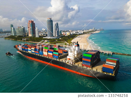 Cargo business. Port of Miami. Cargo ship with container in Miami, aerial view. Freight container on cargo vessel. Cargo ship vessel leaving port. Container ship. Export and import. South beach 133748258