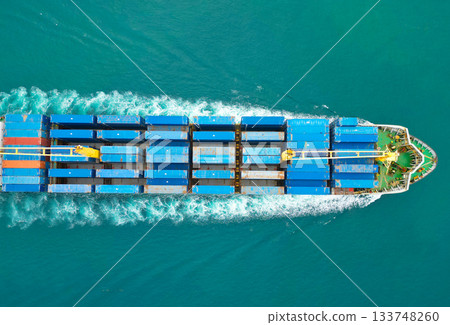 Container ship. Shipping logistics. Commercial shipping. Cargo ship in sea. Freight container loaded on cargo vessel. Aerial view cargo ship entering harbor. Cargo business. Global shipping routes Container ship. Shipping logistics. Commercial shipping. Cargo ship in sea. Freight container loaded on cargo vessel. Aerial view cargo ship entering harbor. Cargo business. Global shipping routes 133748260