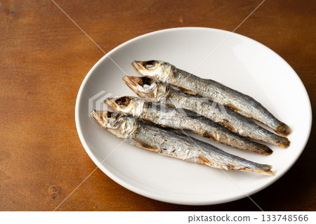 Grilled dried urume (round dried fish) on a plate Grilled dried urume (round dried fish) on a plate 133748566