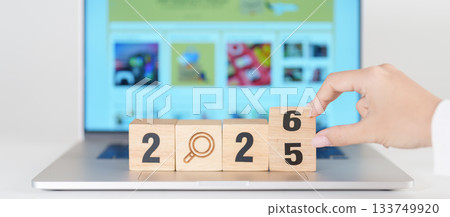 2025 end year to Happy New Year 2026 block magnifying glass icon against laptop background. Hiring, recruitment, job, jobless SEO, Search Engine Optimization and New Year concepts 133749920