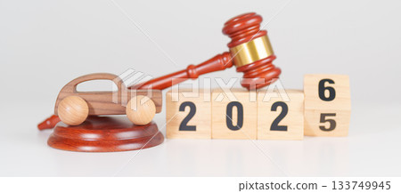 2025 end year to Happy New Year 2026 with small toy car models and Judges gavel on desk in courthouse. Car Law, Insurance, auto Tax, Auction and Bidding concepts 133749945