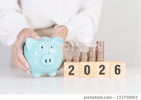 Happy New Year 2026 with piggy bank. Resolution, Goals, Plan, Action, Money Saving, Retirement fund, Pension, Investment and Financial concepts 133750003