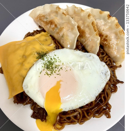 Savory jjapagetti with rich, black bean sauce and chewy noodles, paired with crispy, flavorful mandu. A delicious and satisfying Korean comfort food combination, perfect for any meal! 133750642