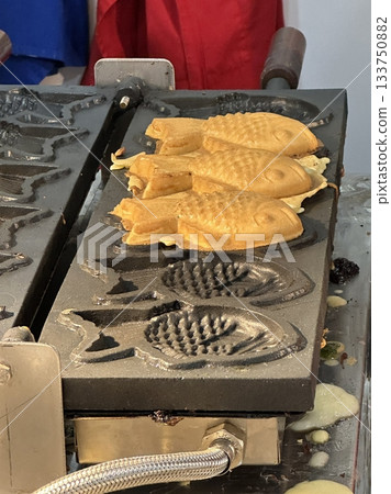 Bungeoppang, bungeo-ppang (Korean Fish Shaped Pastry), popular snack, cookies, sweet in winter streets of Korea. Bungeoppang Korean traditional national food, dish, cuisine. Japanese taiyaki 133750882