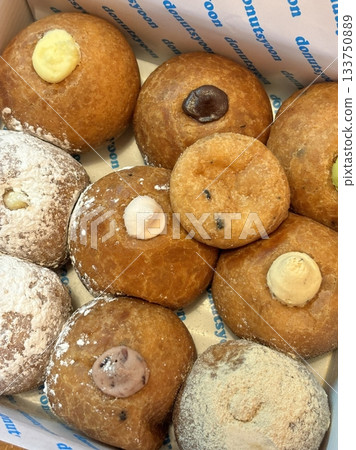 Delicious doughnuts with a golden, fluffy texture, topped with colorful glazes and sprinkles. Perfect for dessert or breakfast photography, showcasing the sweet indulgence of these classic treats. Delicious doughnuts with a golden, fluffy texture, topped with colorful glazes and sprinkles. Perfect for dessert or breakfast photography, showcasing the sweet indulgence of these classic treats. 133750889