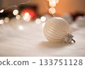 Beautiful white christmas ball on wool with bokeh lights background 133751128