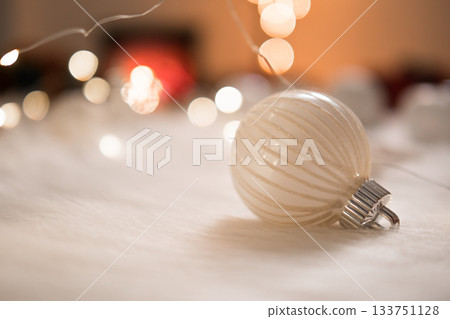 Beautiful white christmas ball on wool with bokeh lights background 133751128