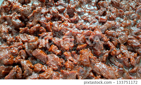 Overhead View of Tender Beef Rendang Chunks Deep Brown Color and Sheen Overhead View of Tender Beef Rendang Chunks Deep Brown Color and Sheen 133751172