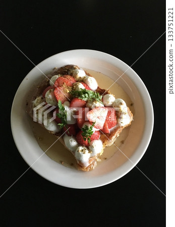 A delectable slice of cake with rich layers of cream and frosting, topped with fresh fruit or sprinkles. Perfect for dessert photography, showcasing indulgence and sweetness in food-related projects. 133751221