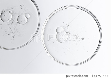 The texture of a cosmetic serum or body gel in a Petri dish. 133751365