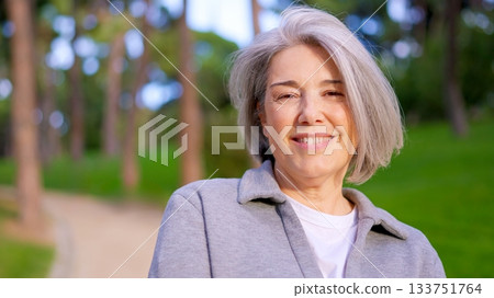 Beautiful senior woman with gray hair smiling outdoors Beautiful senior woman with gray hair smiling outdoors 133751764