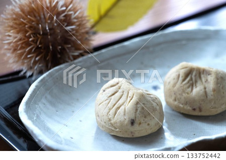 Two souvenir chestnut kintons on a ceramic plate Two souvenir chestnut kintons on a ceramic plate 133752442