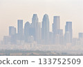 A dense haze hangs over the city skyline, a visual representation of the growing concern for air quality in urban environments. 133752509