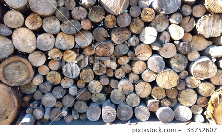 Cut logs piled up in a materials yard 133752607