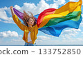 Lgbt flag on woman hand waving in wind. 133752850
