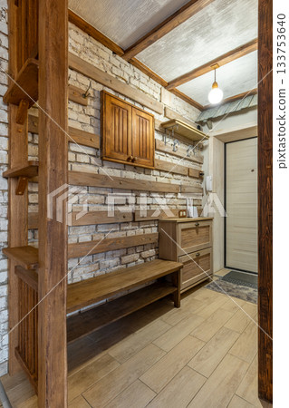 Rustic Hallway Interior with Wooden Bench and Brick Wall 133753640
