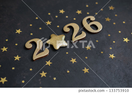 Gold numbers 2026 with star instead of zero on black textured background 133753910