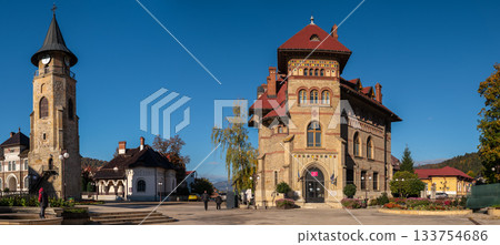 Piatra Neamt historic twin buildings under crisp blue sky Piatra Neamt historic twin buildings under crisp blue sky 133754686