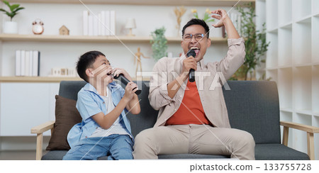 Family Life: Father and son singing together with microphones at home Family Life: Father and son singing together with microphones at home 133755728