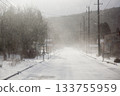 A snowstorm hits the snow-covered road 133755959