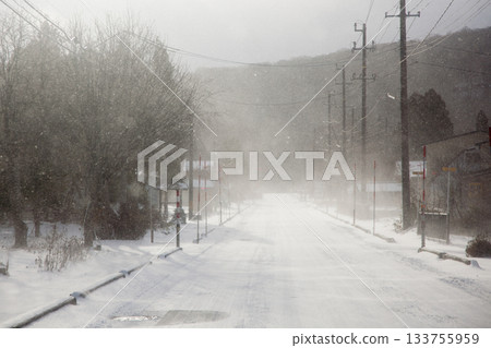 A snowstorm hits the snow-covered road A snowstorm hits the snow-covered road 133755959