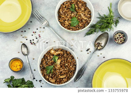 Bowl of buckwheat porridge on table. Bowl of buckwheat porridge on table. 133755978