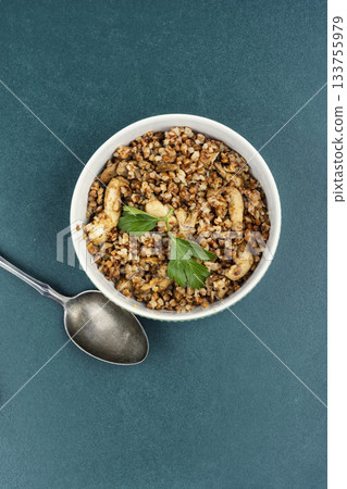 Cooked buckwheat porridge with meat stew. Cooked buckwheat porridge with meat stew. 133755979