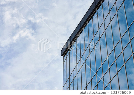 Modern glass office building facade with reflective windows Modern glass office building facade with reflective windows 133756069