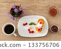Cup of coffee and curd fritters with sour cream and berries on the porcelain plates. 133756706