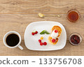 Cup of coffee and curd fritters with sour cream and berries on the porcelain plates. 133756708