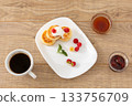 Cup of coffee and curd fritters with sour cream and berries on the porcelain plates. 133756709