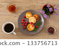 Cup of coffee and curd fritters with raspberries on the wooden background. 133756713