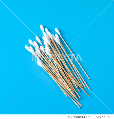 A swab clean health care top view,cotton bud on blue background. A swab clean health care top view,cotton bud on blue background. 133756959